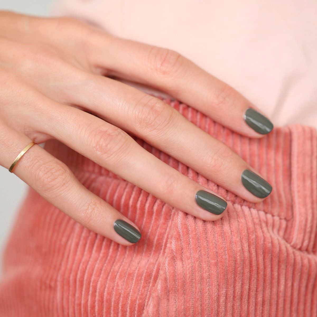 A hand with neatly manicured nails painted in Manucurist&