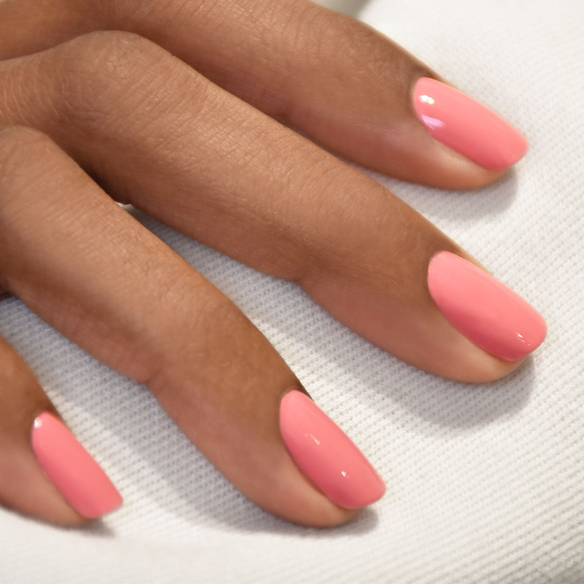 A close-up of a medium brown hand with neatly manicured nails painted with Manucurist&