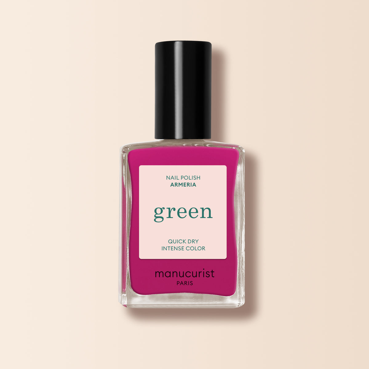 A bottle of Manucurist Armeria nail polish—a vibrant pinky mauve shade with a black cap. The label reads: green, quick dry, intense color.