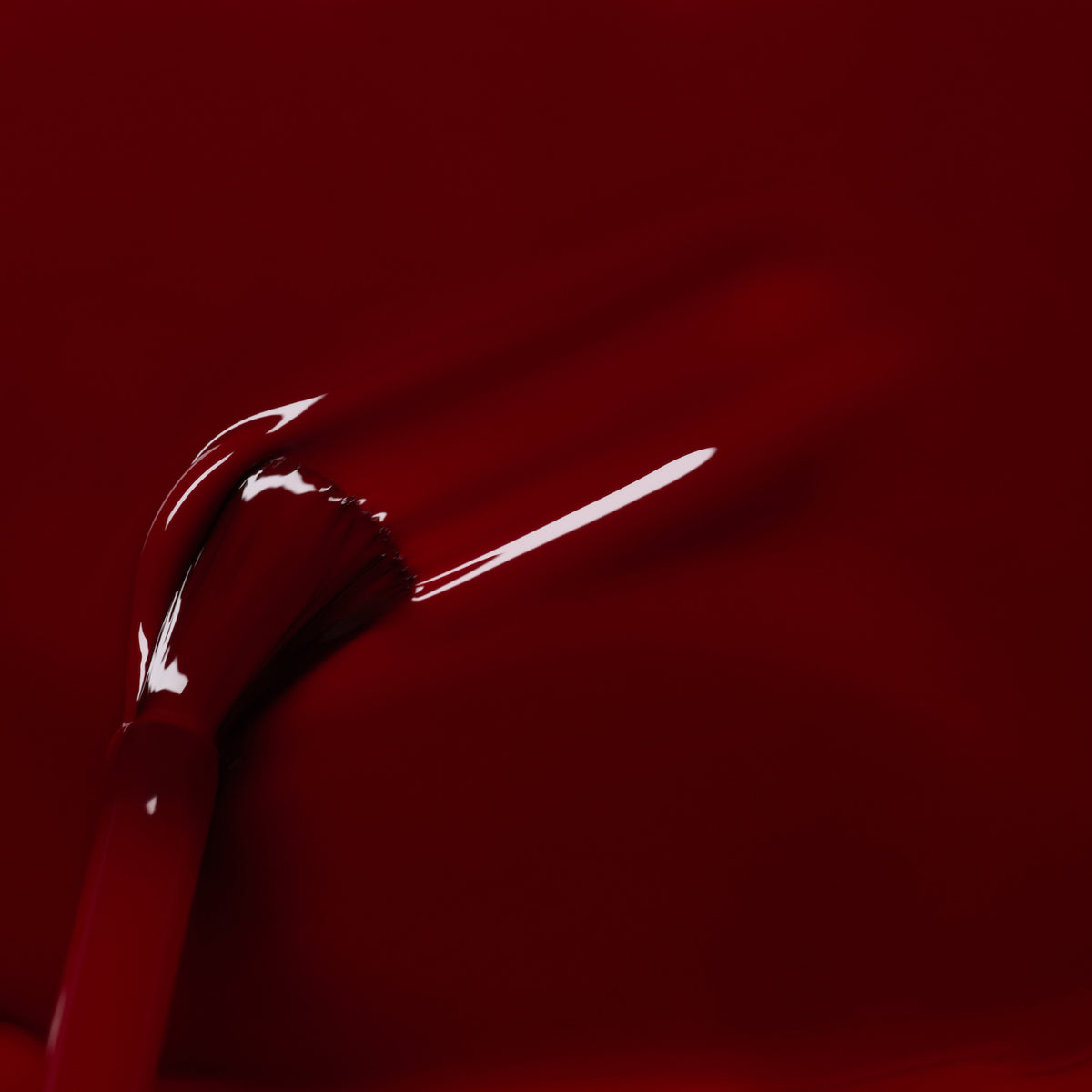 A close-up shows a Manucurist Dark Pansy nail polish brush applying a smooth stroke of glossy velvet red polish, with reflected light highlighting its shine.