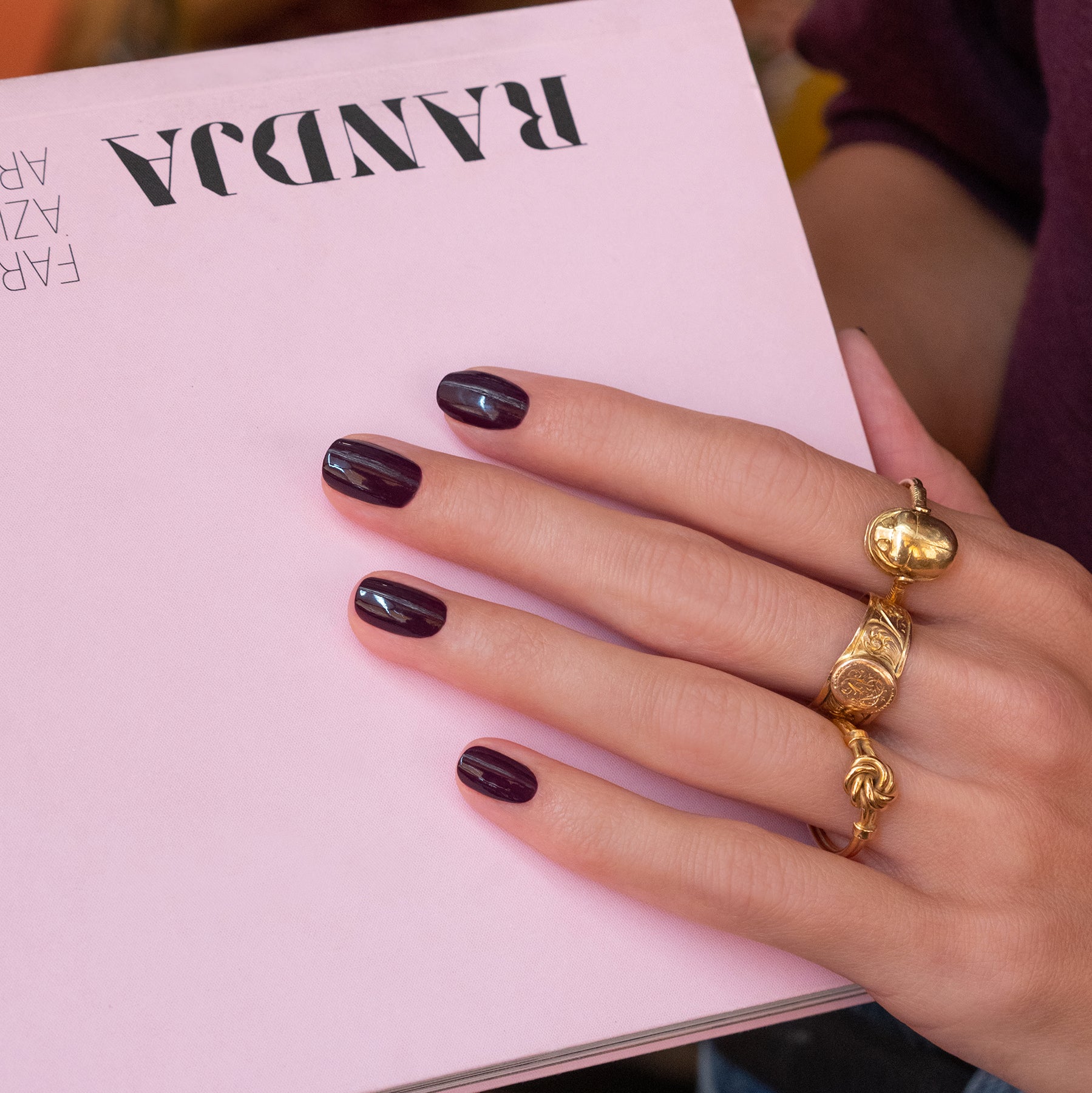 A hand with nails painted in Manucurist&
