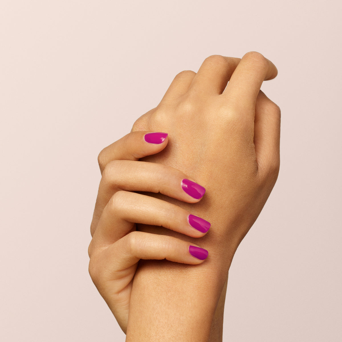 A close-up of two hands with neatly manicured nails painted in Manucurist&