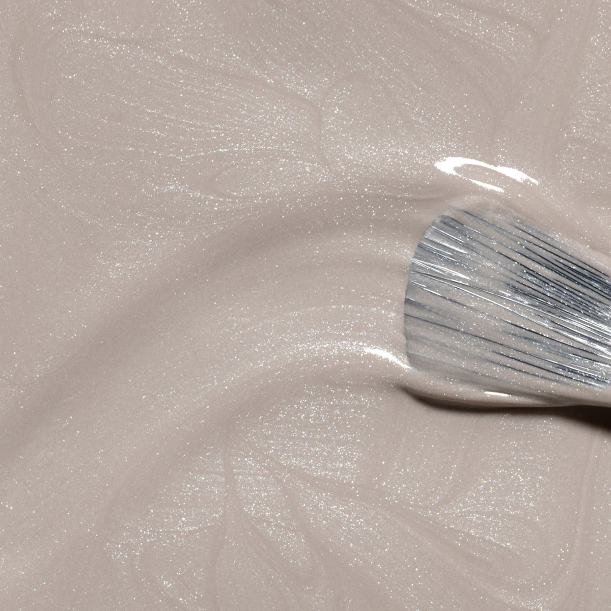 A close-up of a brush applying Manucurist&