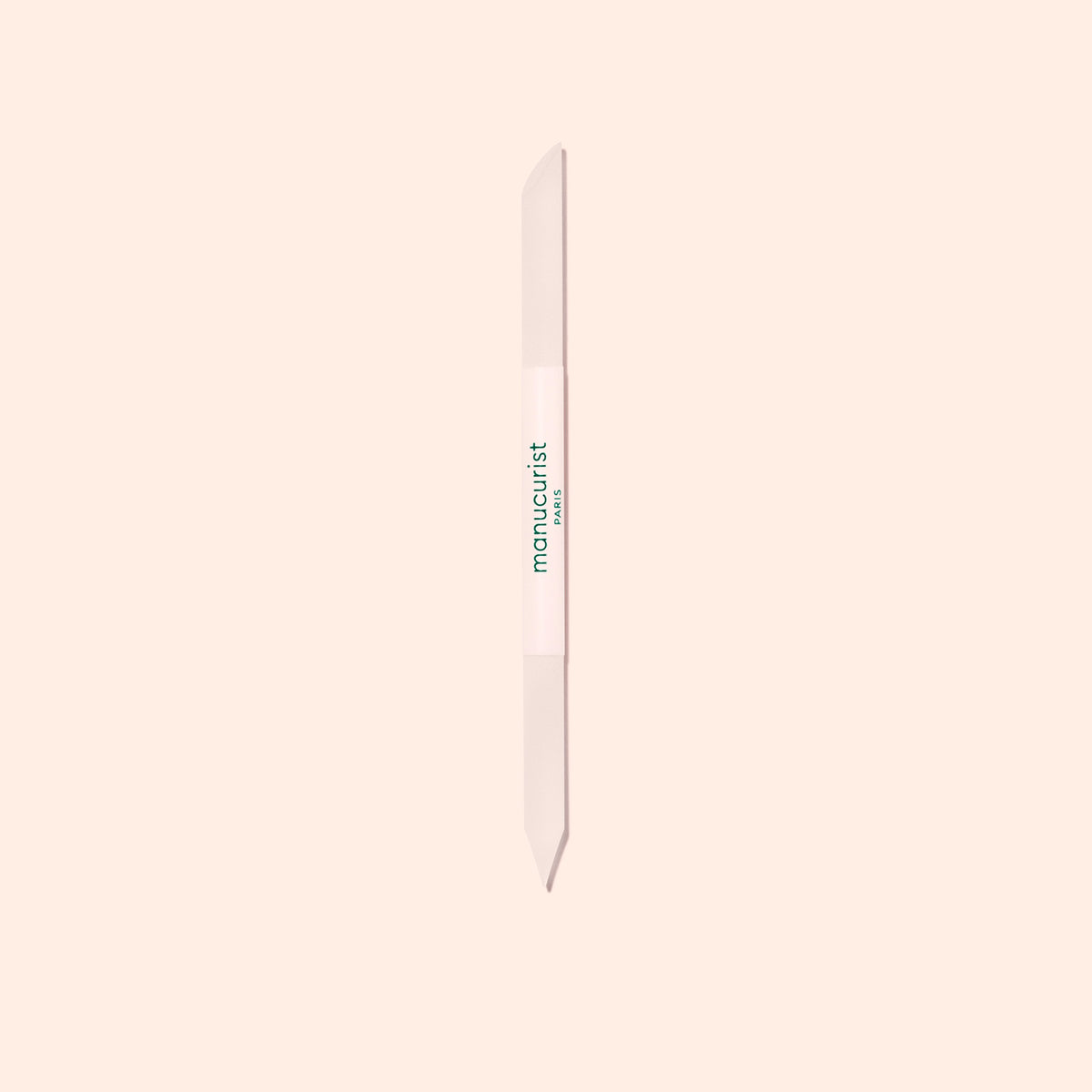 The Manucurist Glass Cuticle Pusher—a clear, dual-tipped tool with a pointed and rounded end, labeled in green—is perfect for precise nail contour care and shown on a light beige background.