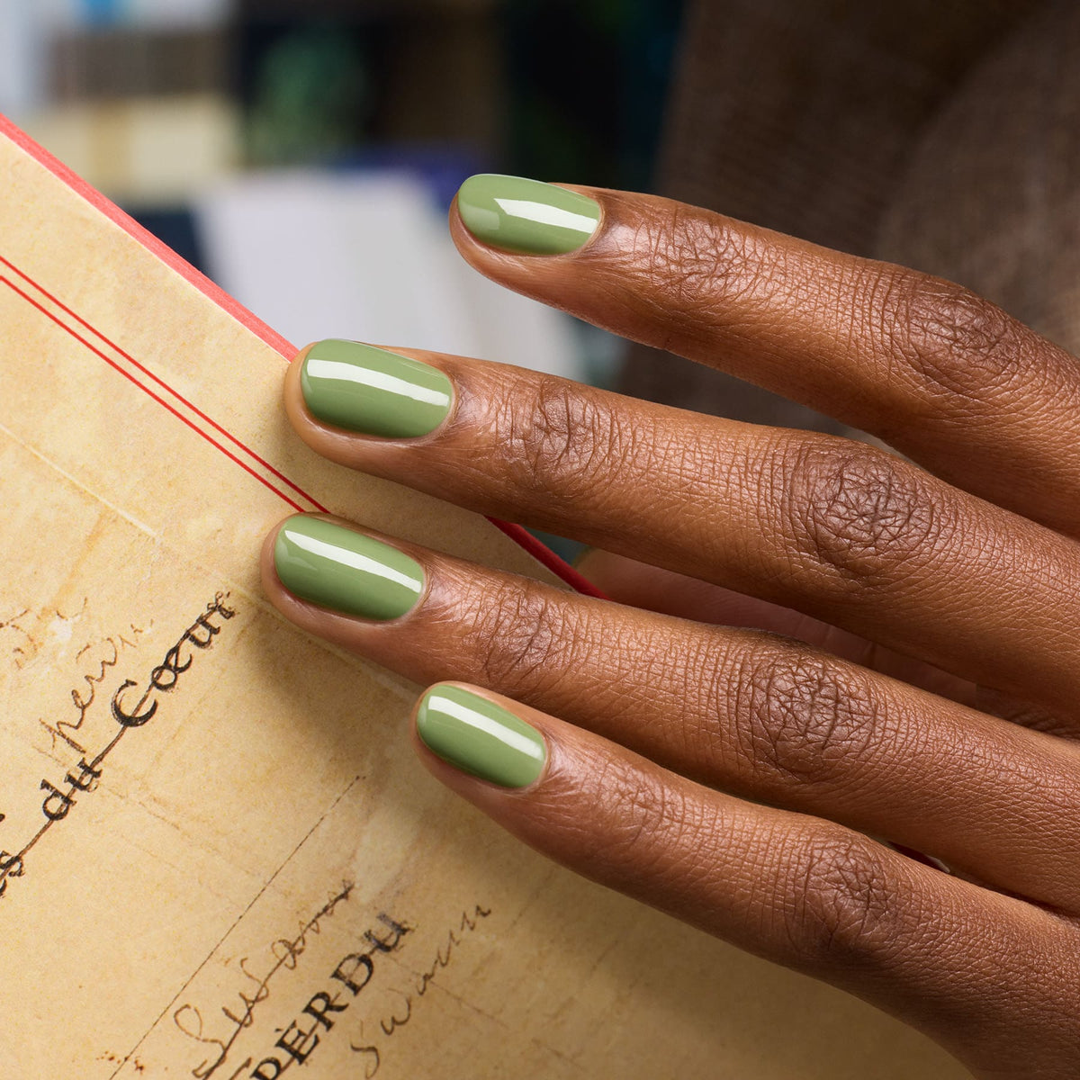 A hand with neatly manicured nails painted in Manucurist&