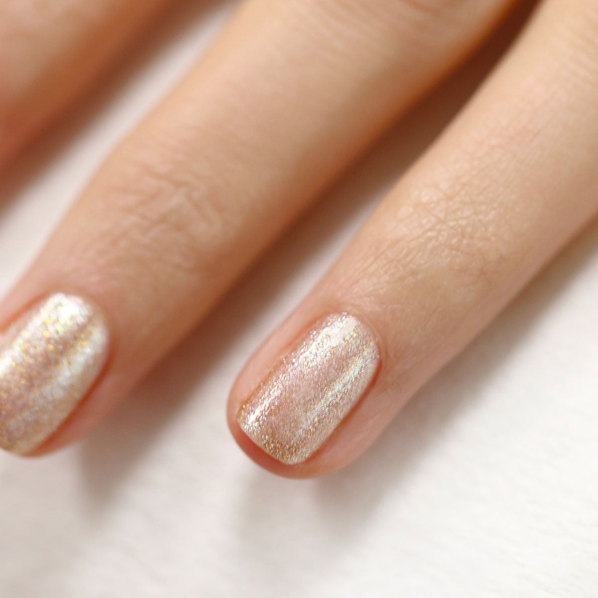Close-up of two fingers with short nails painted in Manucurist&