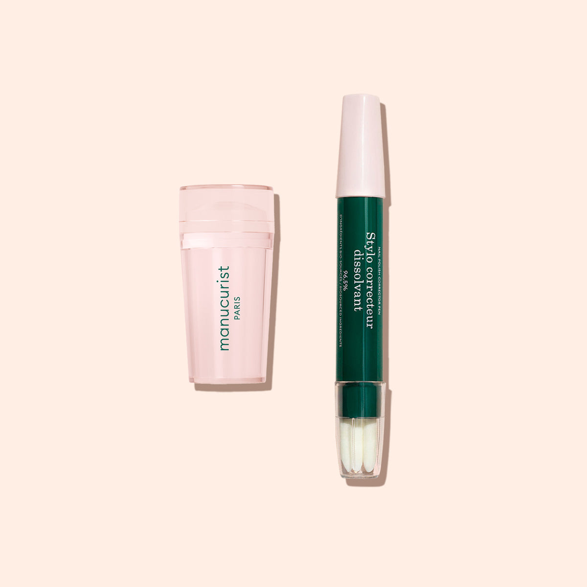 A pale pink Manucurist Mani stamper sits next to a dark green and white pen-shaped corrector, perfect for flawless French tips, both displayed on a light beige background.