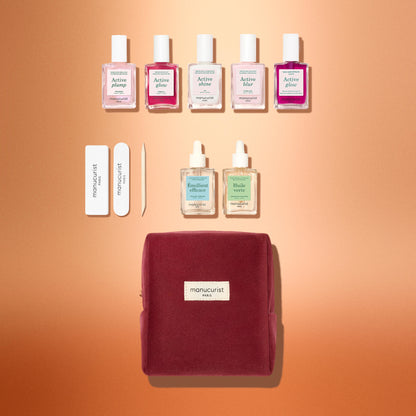 The Manucurist Active™ Starter Kit Gift Set includes five bottles of nail polish, a nail file, a cuticle pusher, two bottles of nail treatment, and a velvet pouch, perfect as a holiday gift.