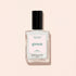 A clear glass bottle of Manucurist nail polish in the shade Nebula, featuring a black cap and white label, is displayed on a pale beige background.