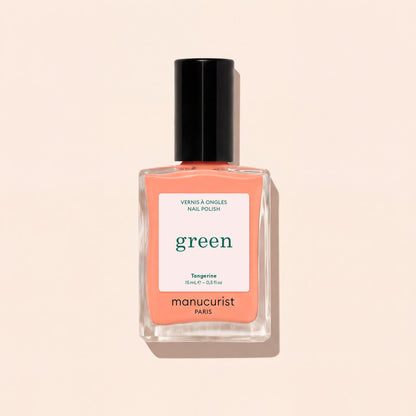 A bottle of Manucurist Tangerine nail polish, a neon light orange shade, features a black cap and minimalist label, displayed on a light beige background.