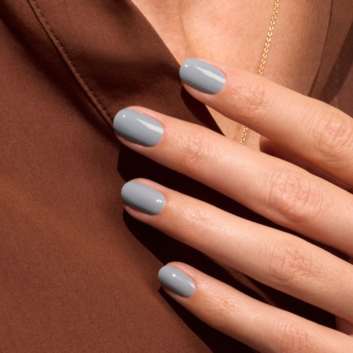 A hand with neatly manicured nails painted in Manucurist&