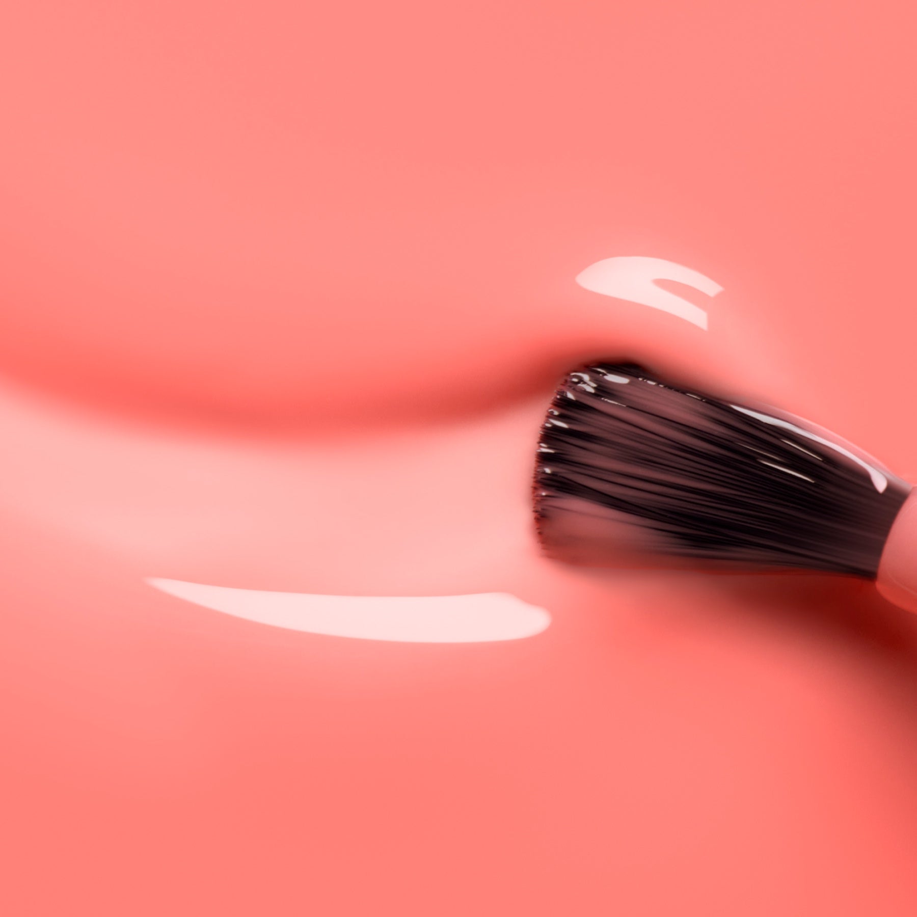 A close-up of a nail polish brush spreading Manucurist&