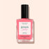 A bottle of Manucurist Sugar Plum nail polish, featuring a translucent pop pink shade with an ultra-glossy finish and a black cap, is shown against a pale pink background.