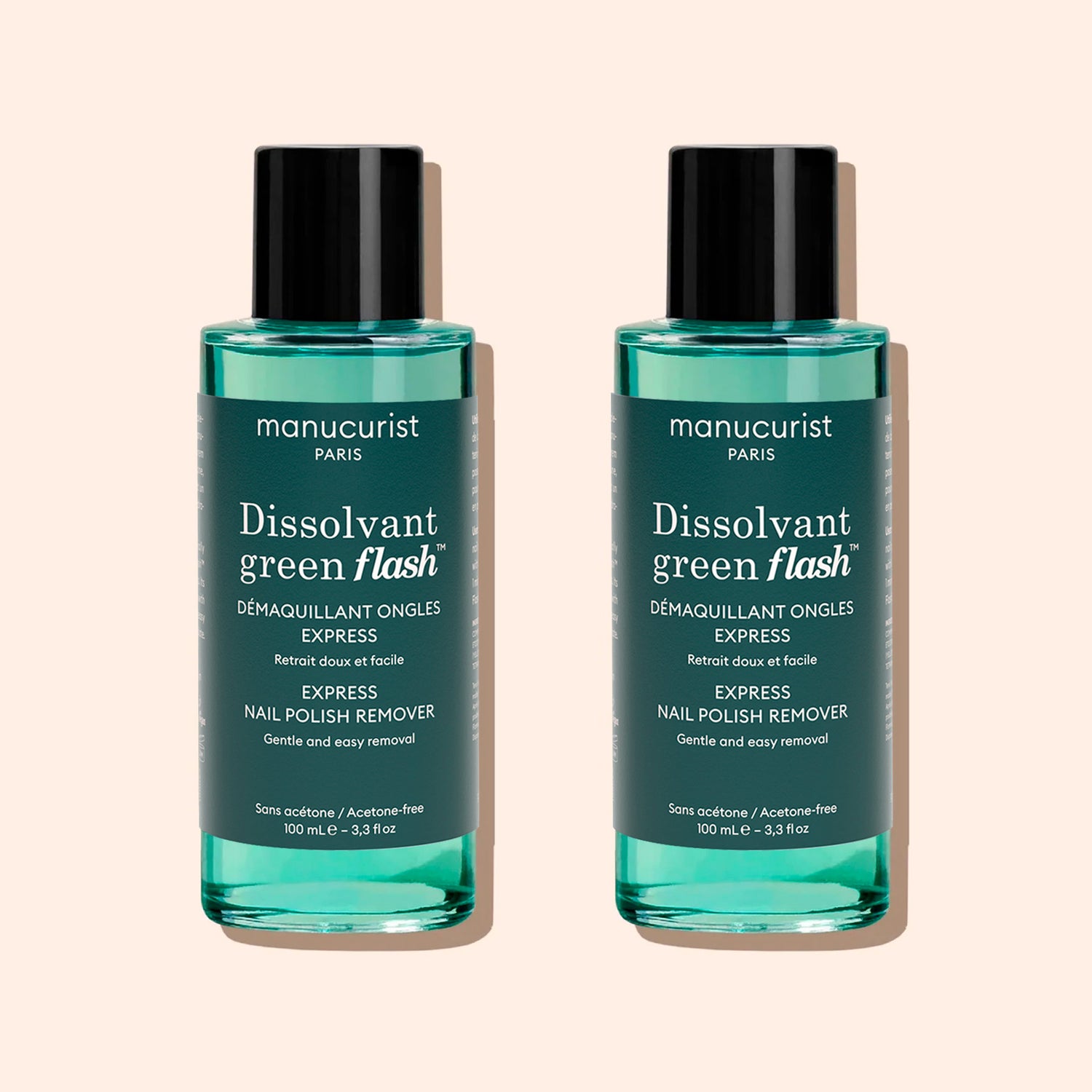 Two bottles of Manucurist Green Flash™ Gel Polish Remover, featuring teal liquid, black caps, and white label text, are displayed against a light beige background.