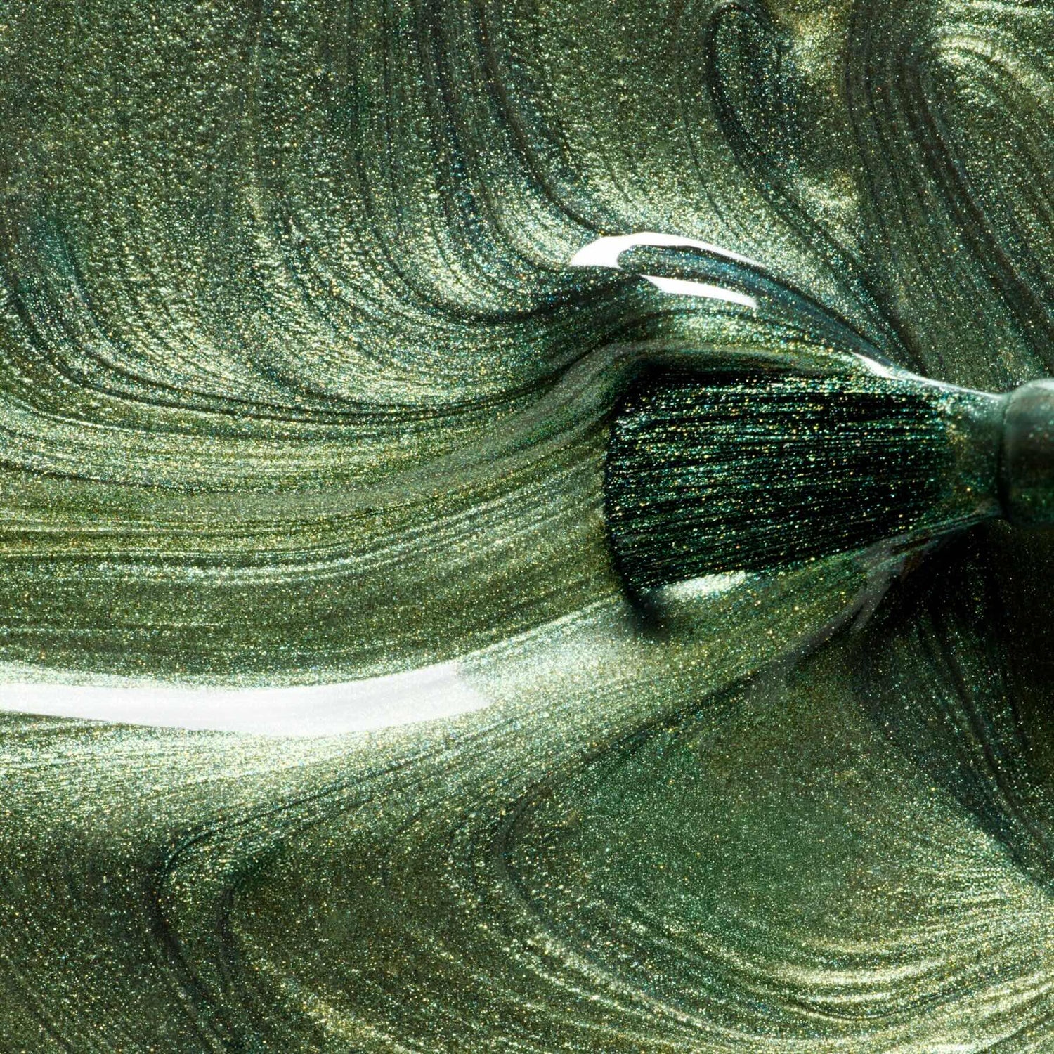 A close-up of a brush swirling Manucurist&