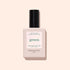 A bottle of Manucurist Glitter Top Coat nail polish with a black cap, shown on a light beige background. The label in English and French highlights its gel-like finish and gold shimmer glitter effect.