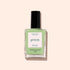 A bottle of Manucurist’s Milky Matcha nail polish, distinguished by its sleek black cap and delicate botanical hues, from The Green range, is displayed against a light beige background.