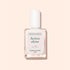 A bottle of Manucurist Active™ Shine Icy nail polish sits on a pale peach background with a subtle shadow, offering the perfect touch for brighter-looking nails and advanced nail care.