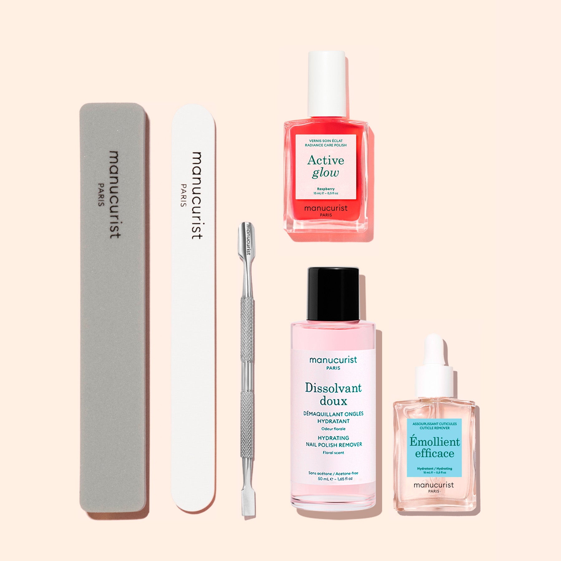 The Manucurist Active™ Discovery Kit features essential manicure tools for your nail care routine—including a gray nail file, white buffer, metal cuticle pusher, pink nail polish, nail polish remover, and a nourishing bottle of nail oil—all beautifully arranged on a light beige background.