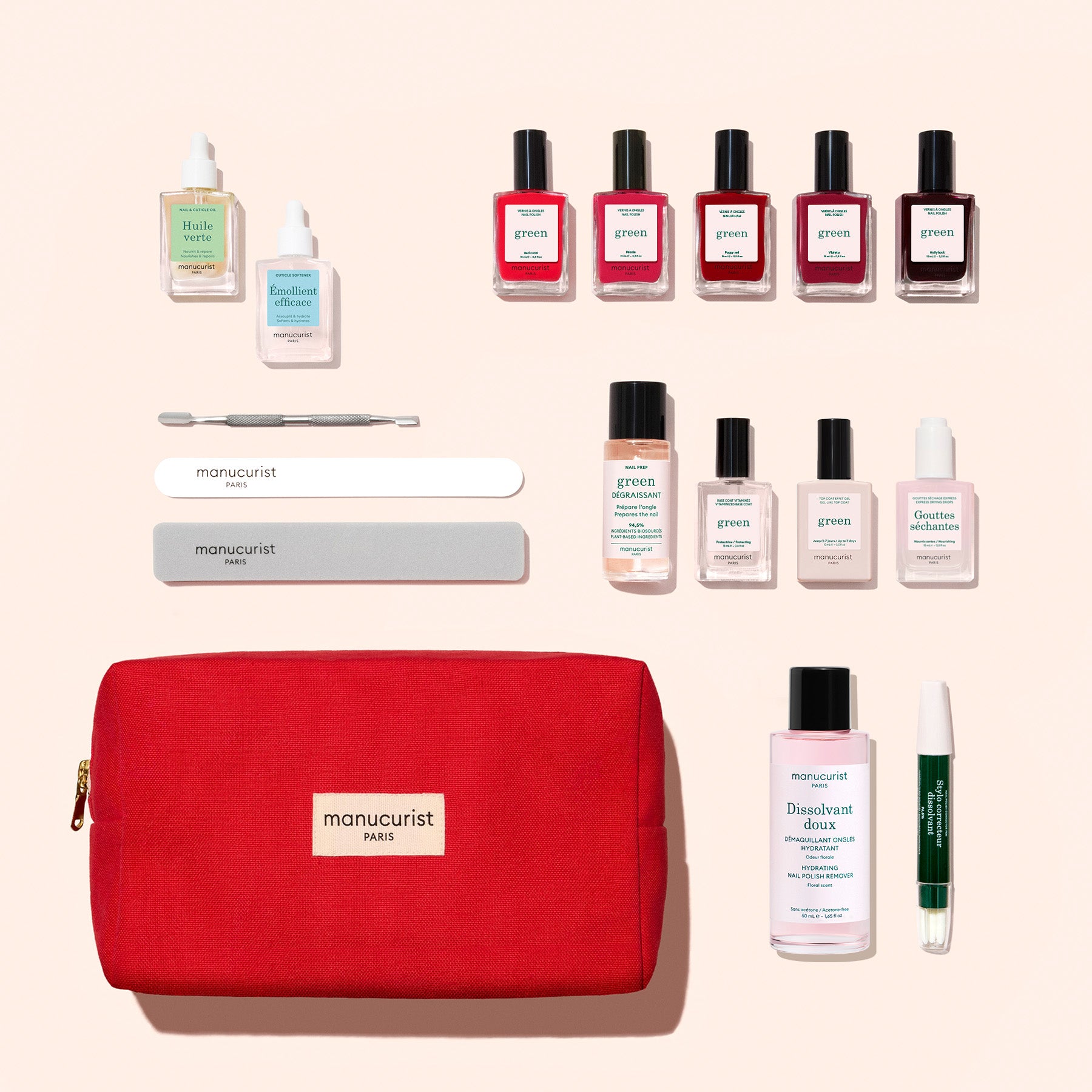 The Manucurist Super Addict Kit features a vibrant red pouch, an array of nail polishes, nail care bottles, a nail file, buffer, cuticle stick, and a green pen—all thoughtfully arranged for everything you need to create the perfect at-home or gel effect manicure.