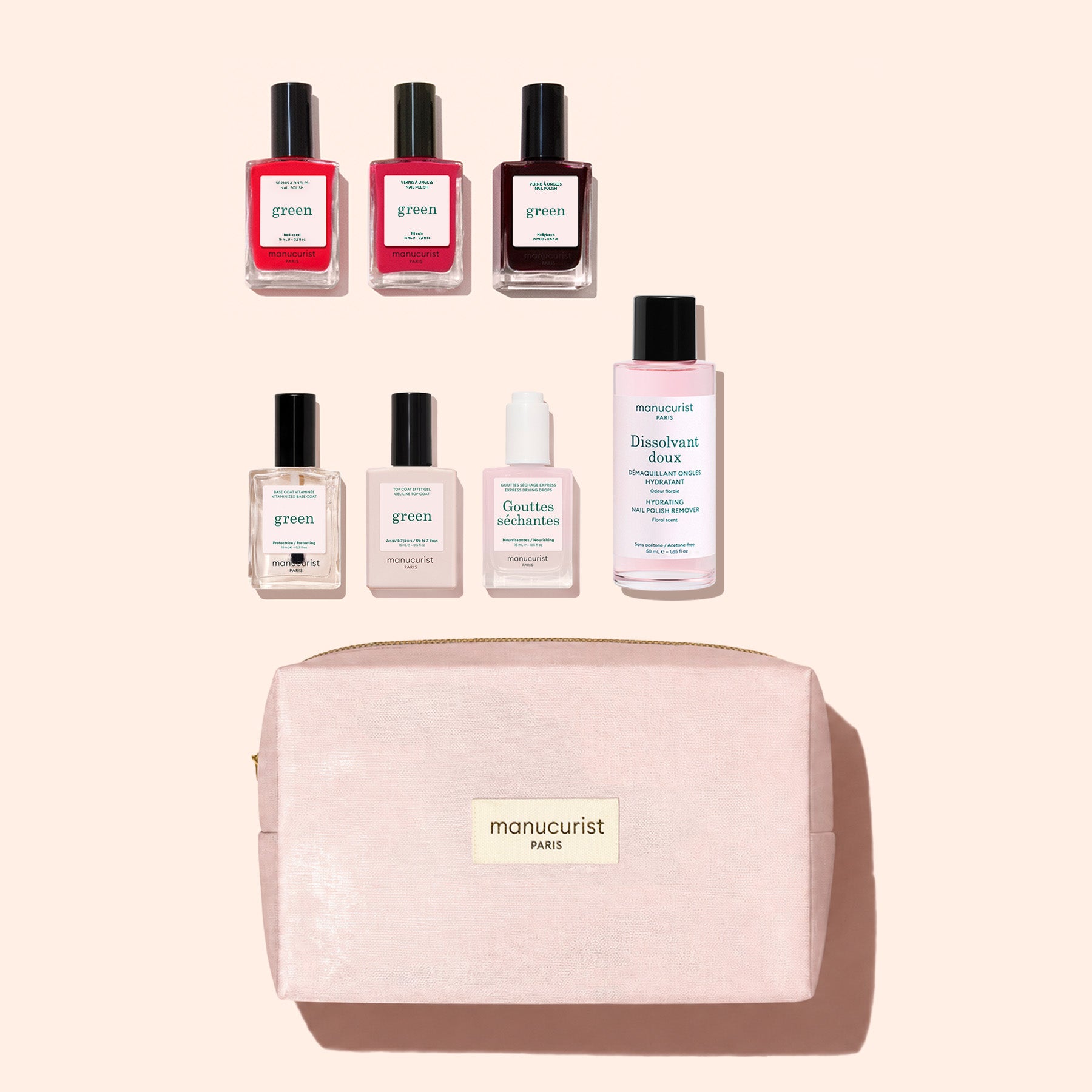 Six gel-effect Manucurist nail polish bottles, one nail polish remover, a small bottle, and a pink organic cotton pouch with a gold “manucurist PARIS” label are all arranged neatly on a pale background, creating the chic Manucurist Starter Kit.