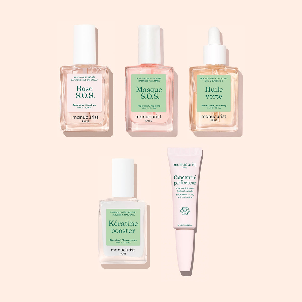 Three glass nail care bottles and one tube of Basic Routine - Damaged Nails arranged on a light background.