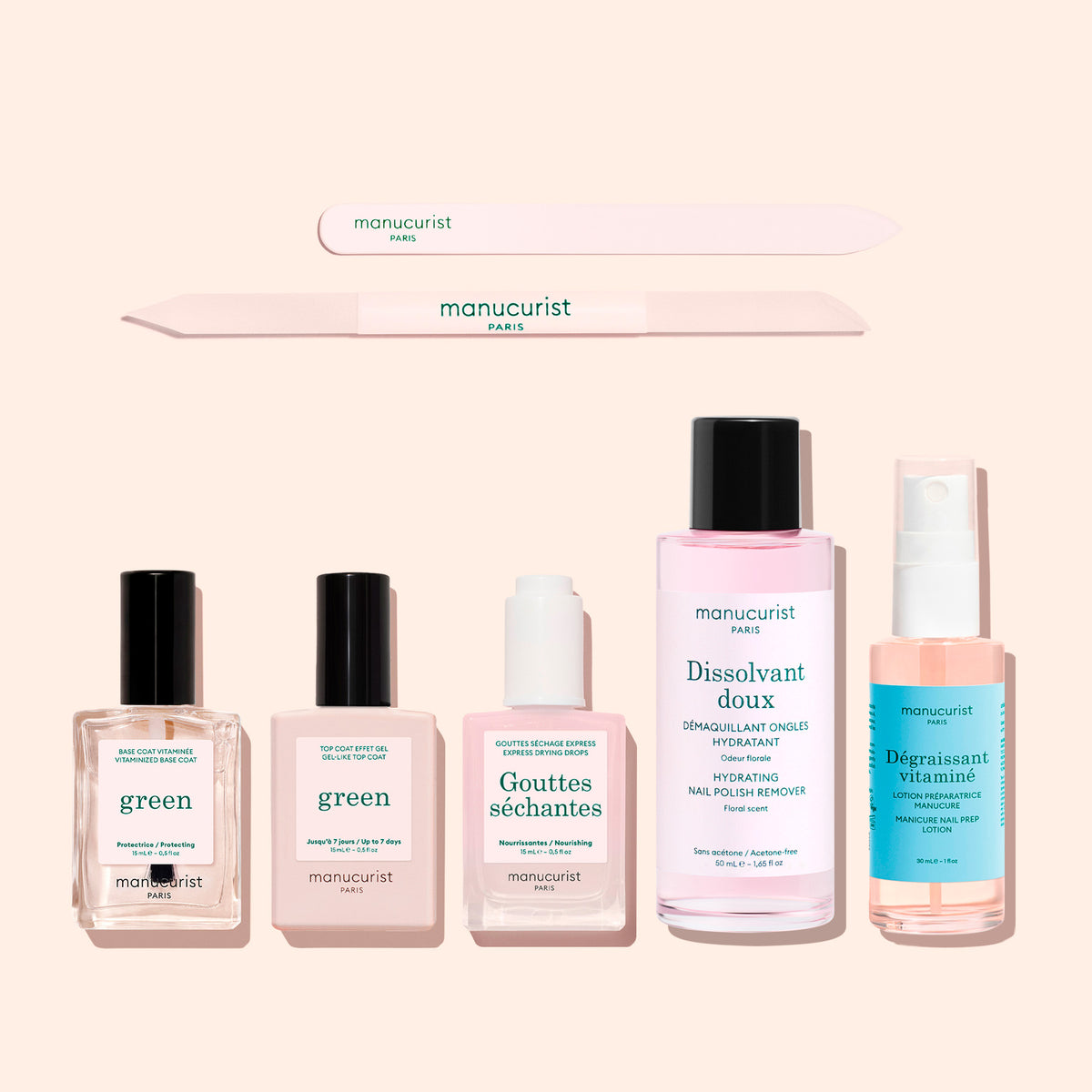 Two nail files positioned above the five bottles of The Essentials of the Green™ System, including a base coat, top coat, drying drops, nail polish remover, and nail prep lotion.