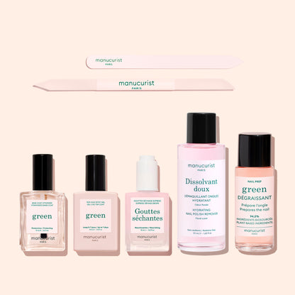The Essentials of the Green™ System by Manucurist features two nail files, three liquid bottles, and a dropper bottle—ideal for eco-conscious nail care—all arranged on a light beige background.