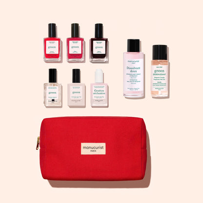 A Manucurist Starter Kit is displayed, featuring a red organic cotton pouch and seven nail care bottles—including gel-effect nail polish, remover, and care products—arranged neatly above the pouch on a light beige background.