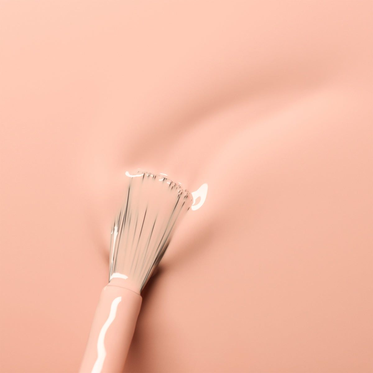 A soft makeup brush glides over Manucurist&