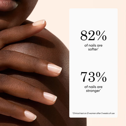 Close-up of a woman’s hand with manicured nails touching her shoulder, highlighting the effects of Manucurist Active™ Shine Icy. Beside her, text reads: 82% of nails are softer. 73% of nails are stronger. Based on clinical testing.
