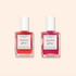 Two bottles of Manucurist Active™ Duo nail care are displayed on a light beige background. The vibrant duo features pink-toned liquid to promote natural nails and provide gentle repair.