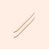 Two Manucurist UK Wooden cuticle sticks (x2), each featuring a pointed tip and a flat angled end for nail cleaning or pushing back cuticles, are arranged parallel to one another on a light beige background.