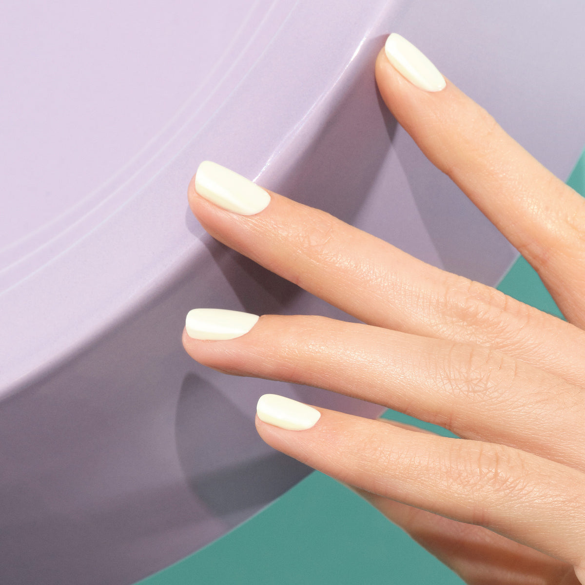 A hand with neatly manicured nails painted in Manucurist&