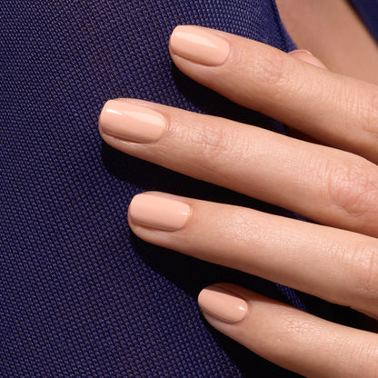 A close-up of a hand with short, neat nails painted in Manucurist&