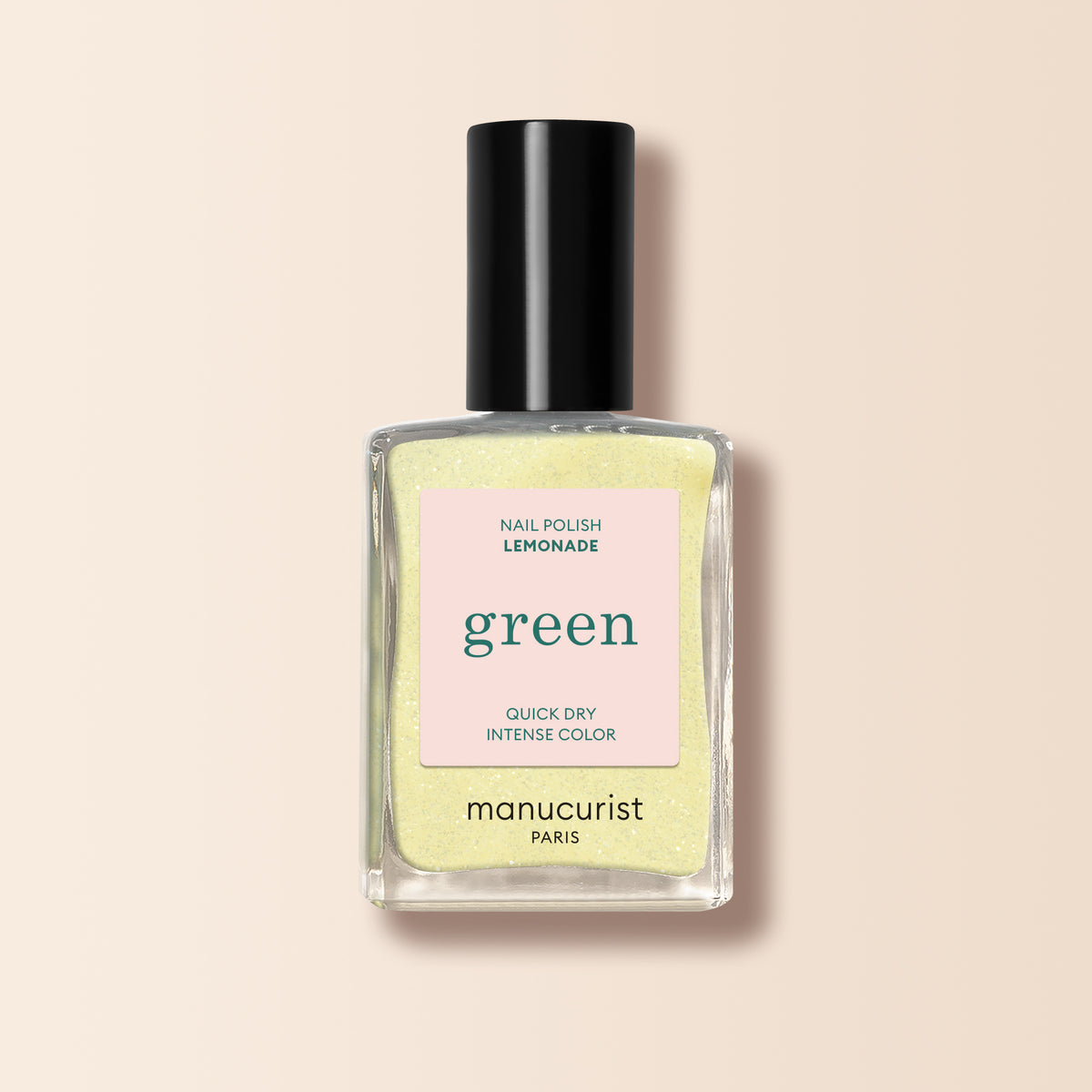A bottle of Manucurist Lemonade polish: pale yellow shade, black cap, "green" label, quick dry, intense color.