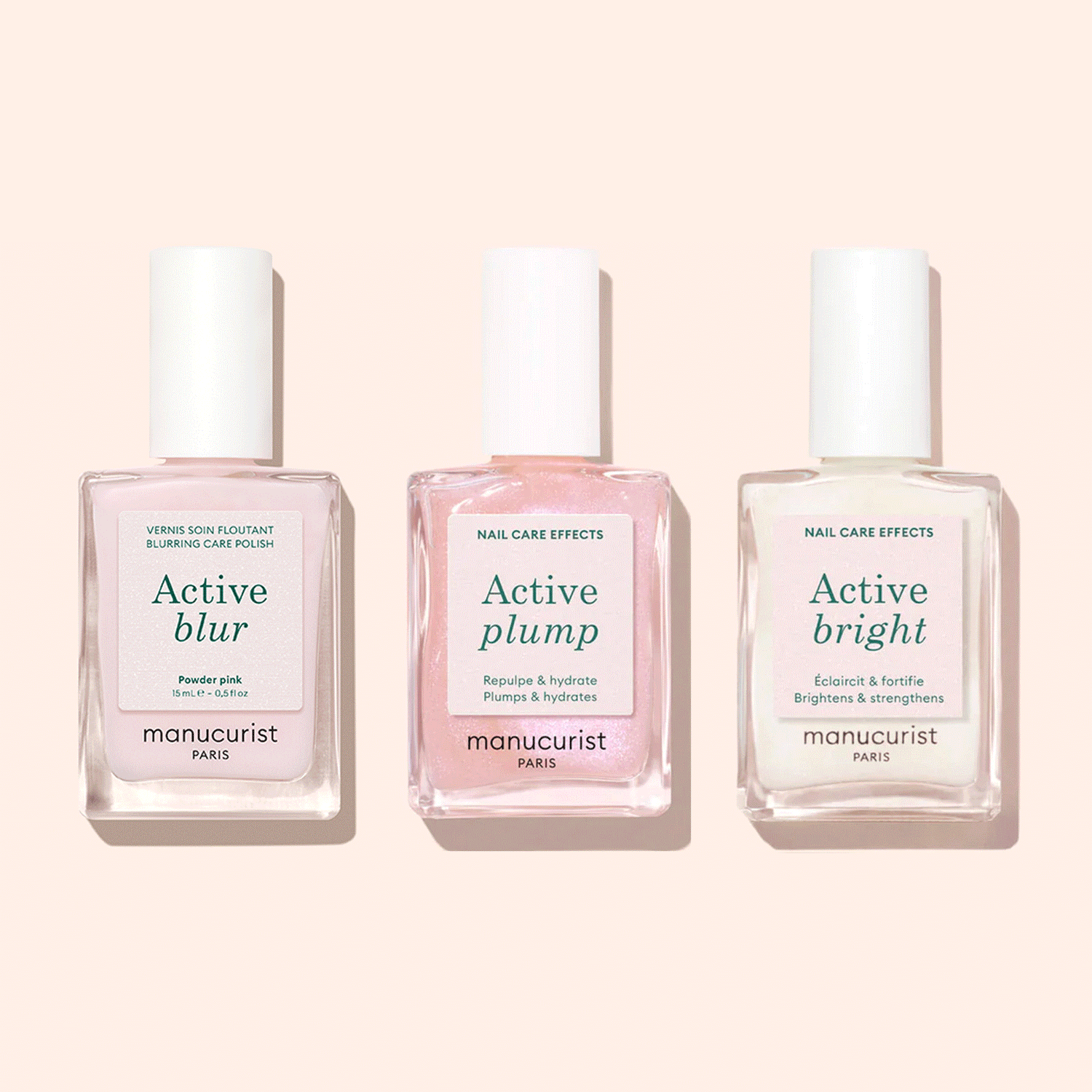 Three bottles of Manucurist Customisable Trio Active™ nail care polishes—Active Blur, Active Plump, and Active Bright—are displayed side by side on a light pink background, each delivering a unique effect for personalised nails.