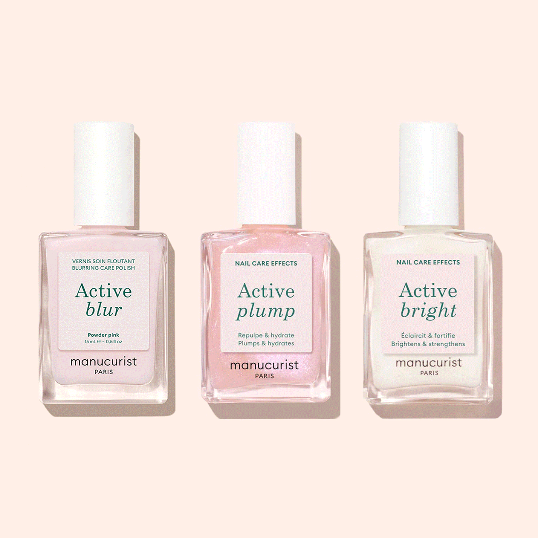 Three bottles of Manucurist Customisable Trio Active™ nail care polishes—Active Blur, Active Plump, and Active Bright—are displayed side by side on a light pink background, each delivering a unique effect for personalised nails.