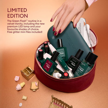 A hand reaches into a red velvet vanity case from the Green Flash™ Starter Kit Gift Set, featuring salon-style manicure tools, nail polish bottles, and an LED lamp next to promotional text.