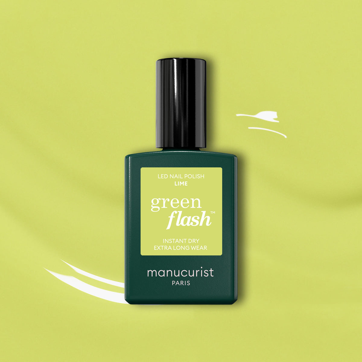 A bottle of Manucurist Lime gel polish stands against a vivid green backdrop with white streaks, highlighting the bold anise green shade.