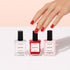 A hand with glossy red nails reaches toward Manucurist&