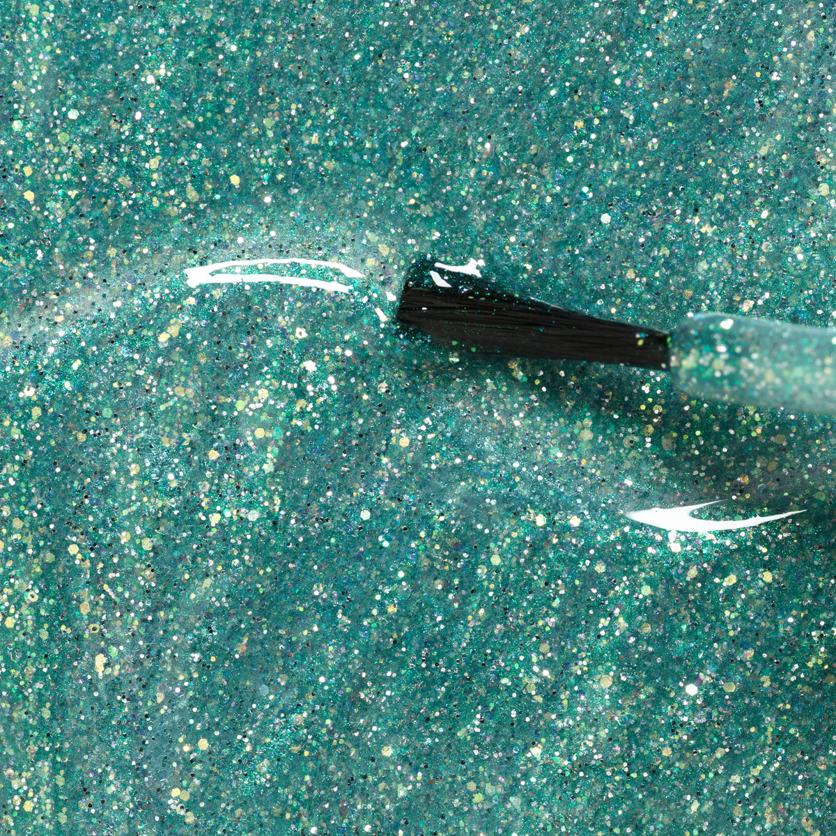 A close-up of a brush spreading Manucurist&