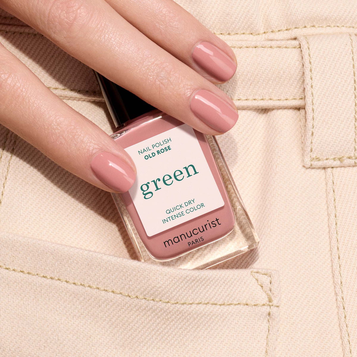 A hand with neatly manicured nails painted in Manucurist&