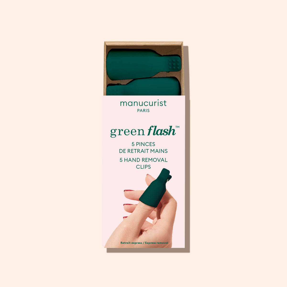 A box of Manucurist Nail Clips features five dark green nail clips visible alongside an image of a hand using a clip on the front of the packaging, designed for quick gel polish removal.