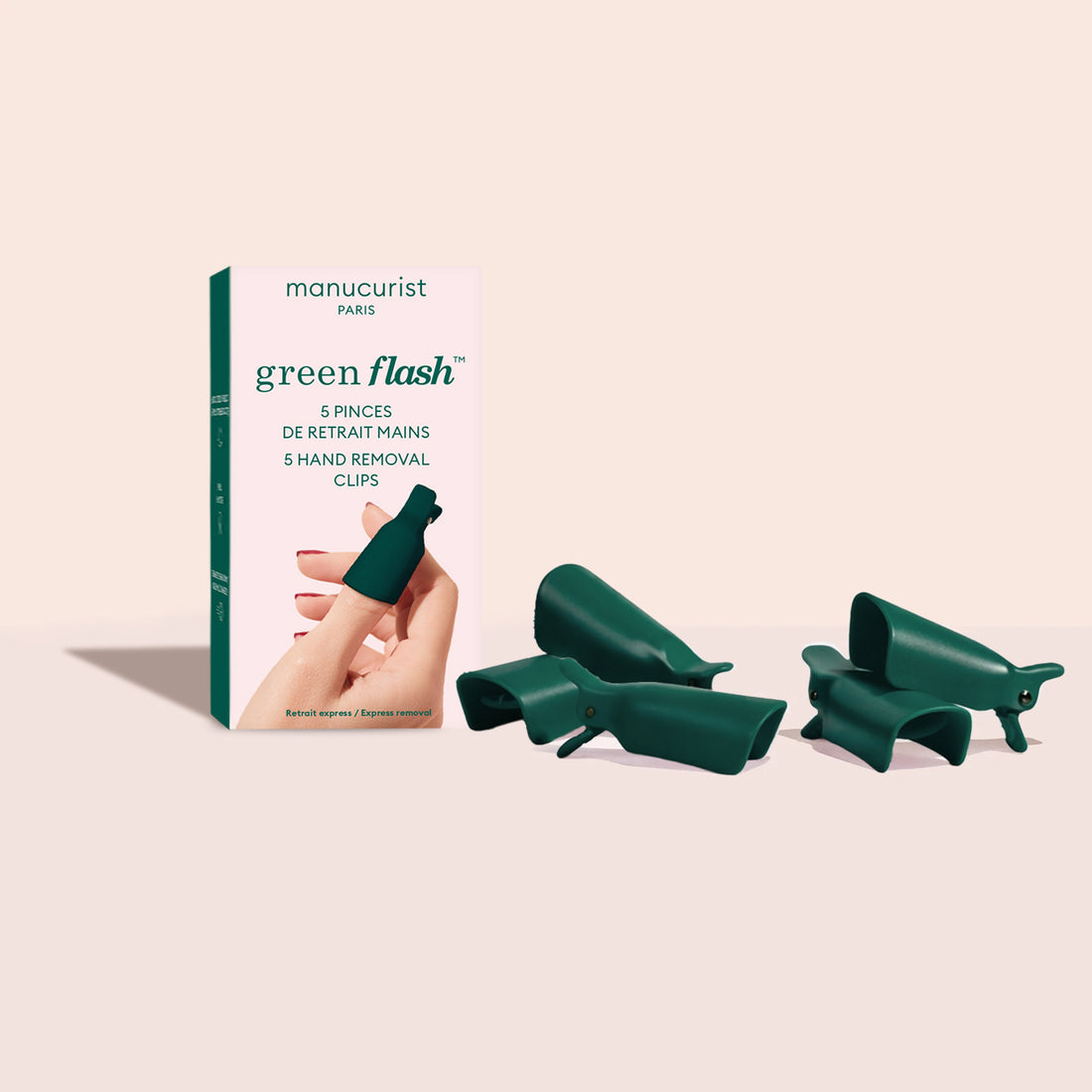 A box labeled Manucurist Nail Clips, featuring an illustration of a hand and green removal clips, is showcased—ideal for fast gel polish removal. Five green Manucurist Nail Clips, designed as effective gel polish remover tools, are displayed beside the box on a light background.