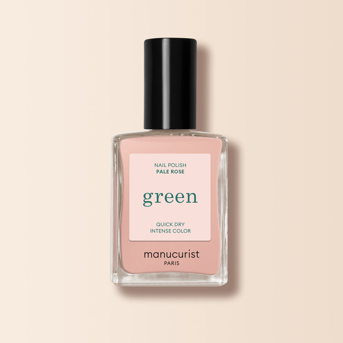 A bottle of Manucurist-test nail polish, Pale Rose - Free, features a black cap, clear glass, and a light pink label reading "green," "Quick Dry Intense Color," and "Nail Polish Pale Rose.