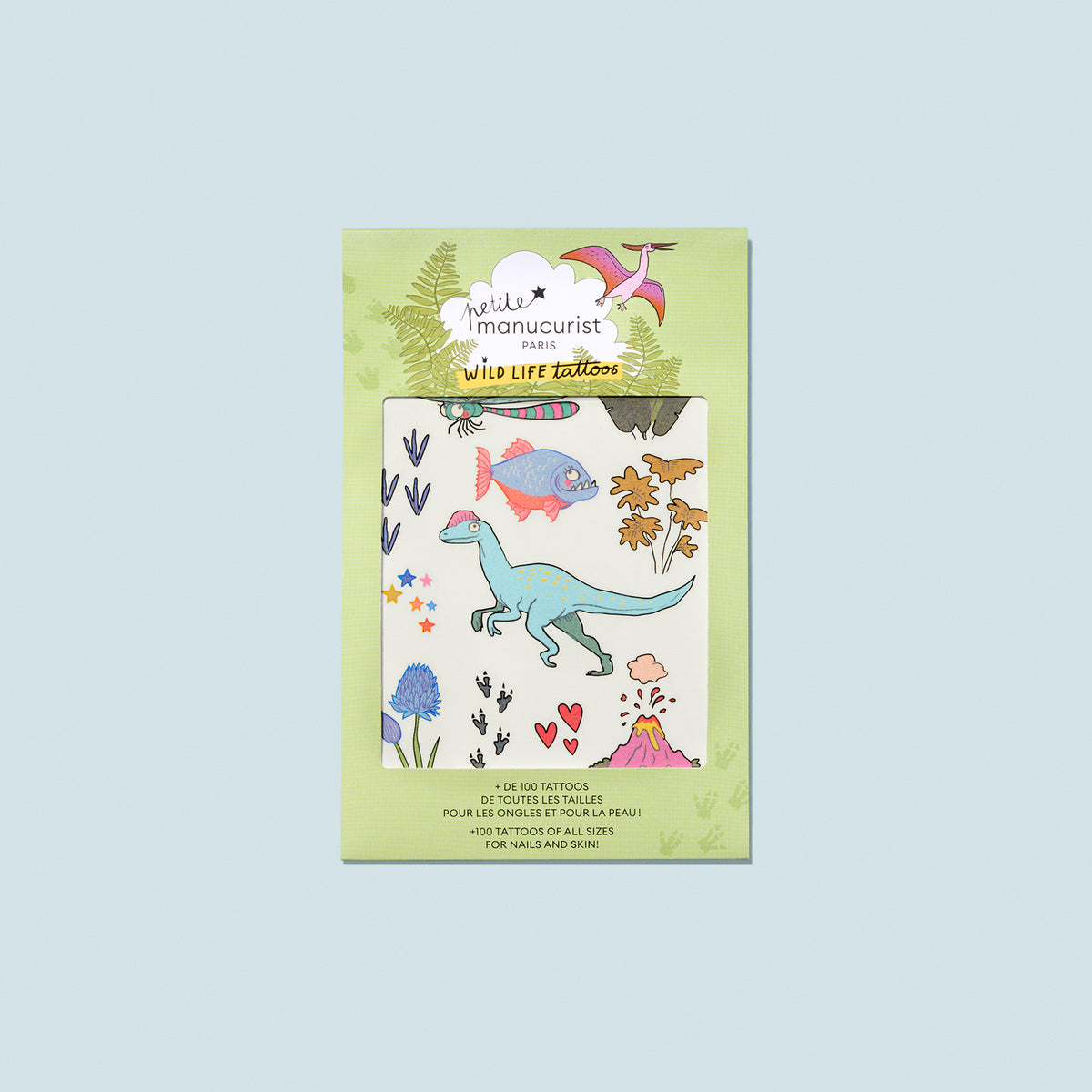 Wild Life Tattoos by Manucurist: a set of colorful temporary body tattoos featuring dinosaurs, fish, birds, animal tracks, leaves, flowers, and stars—perfect for back-to-school fun on a light green background.