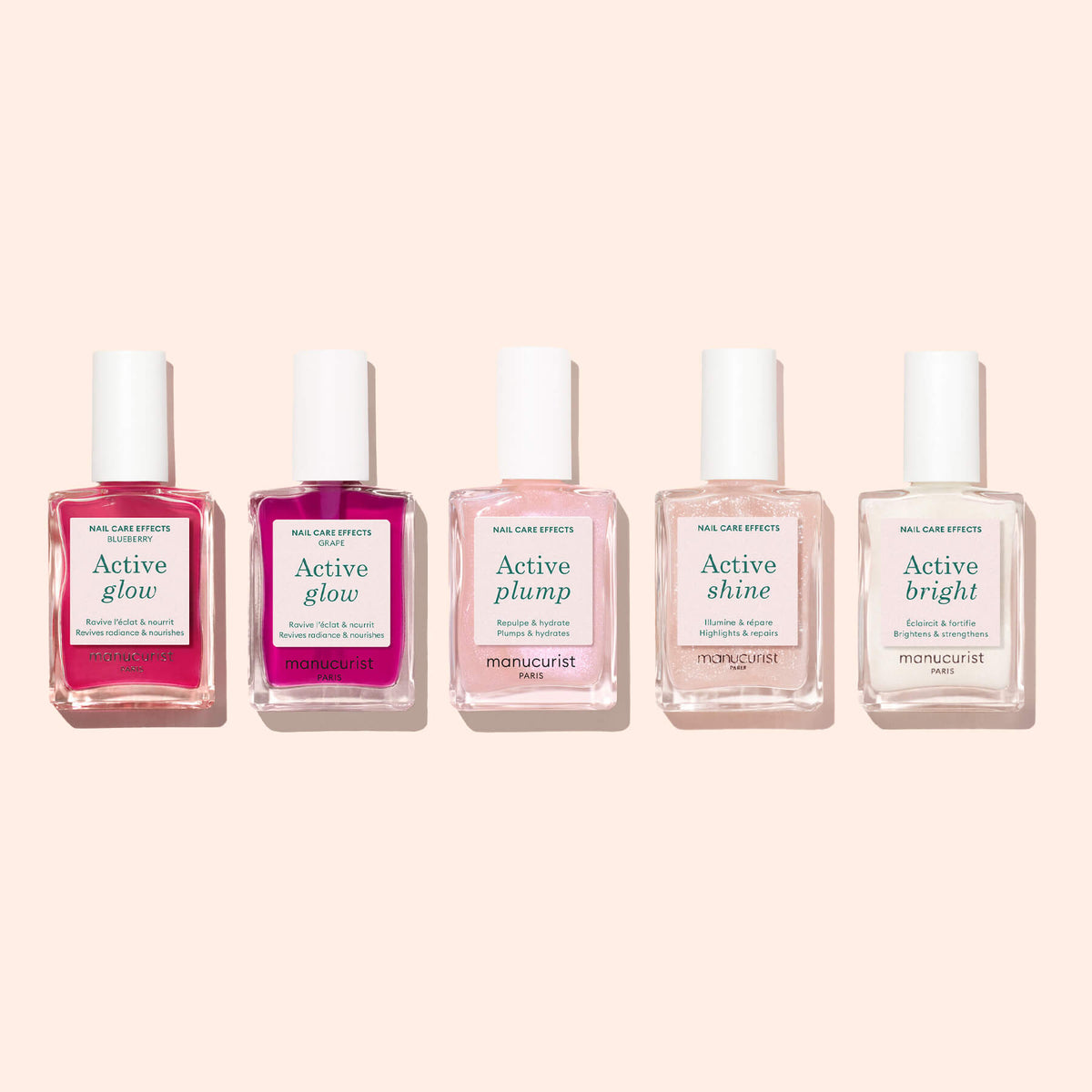 A bottle of Manucurist Active™ Glow Blueberry nail care polish sits on a light beige background, showcasing its specially formulated blend for nail nourishment. This polish enhances the overall look and health of your nails while delivering a radiant shine.