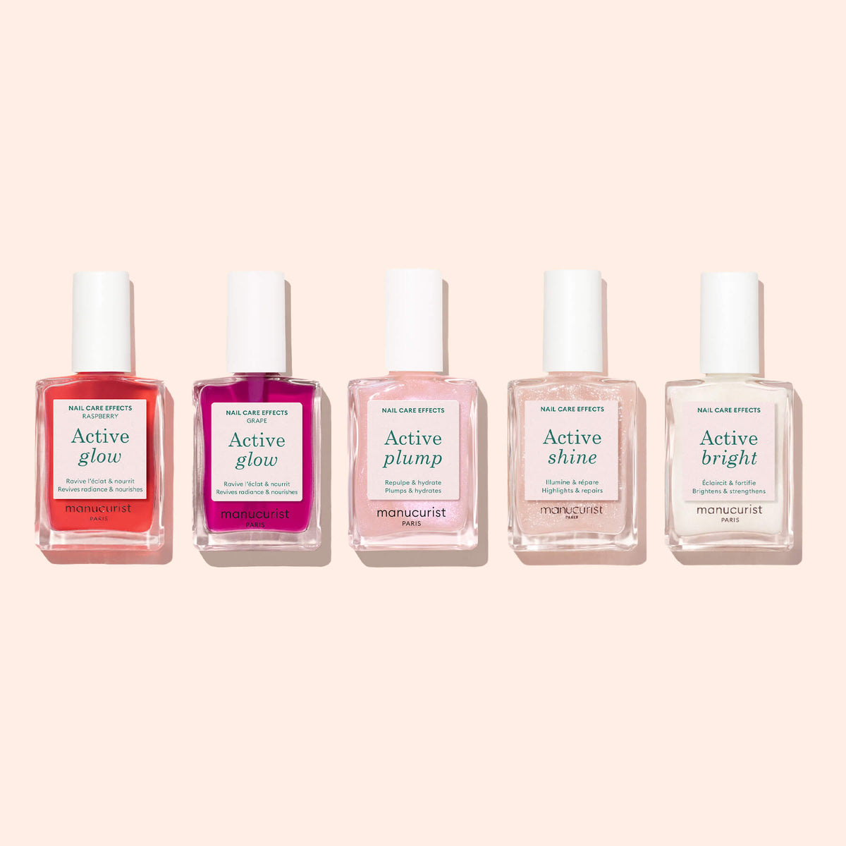 Five bottles of Manucurist nail care products, including Active™ Glow Raspberry, Active Plump, Active Shine, and Active Bright, are arranged in a row on a light pink background to showcase the ultimate collection for natural radiance and effective nail care.
