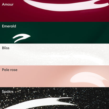 Five nail polish swatches labeled Amour (dark red), Emerald (dark green), Bliss (white), Pale Rose (light pink), and Sparks (black with glitter) are displayed, each with a swoosh of glossy polish. The Manucurist Customisable Rainbow Green set features eye-catching shades—including dazzling green—perfect for anyone who loves trying bold colors or creating their own unique rainbow nail look.